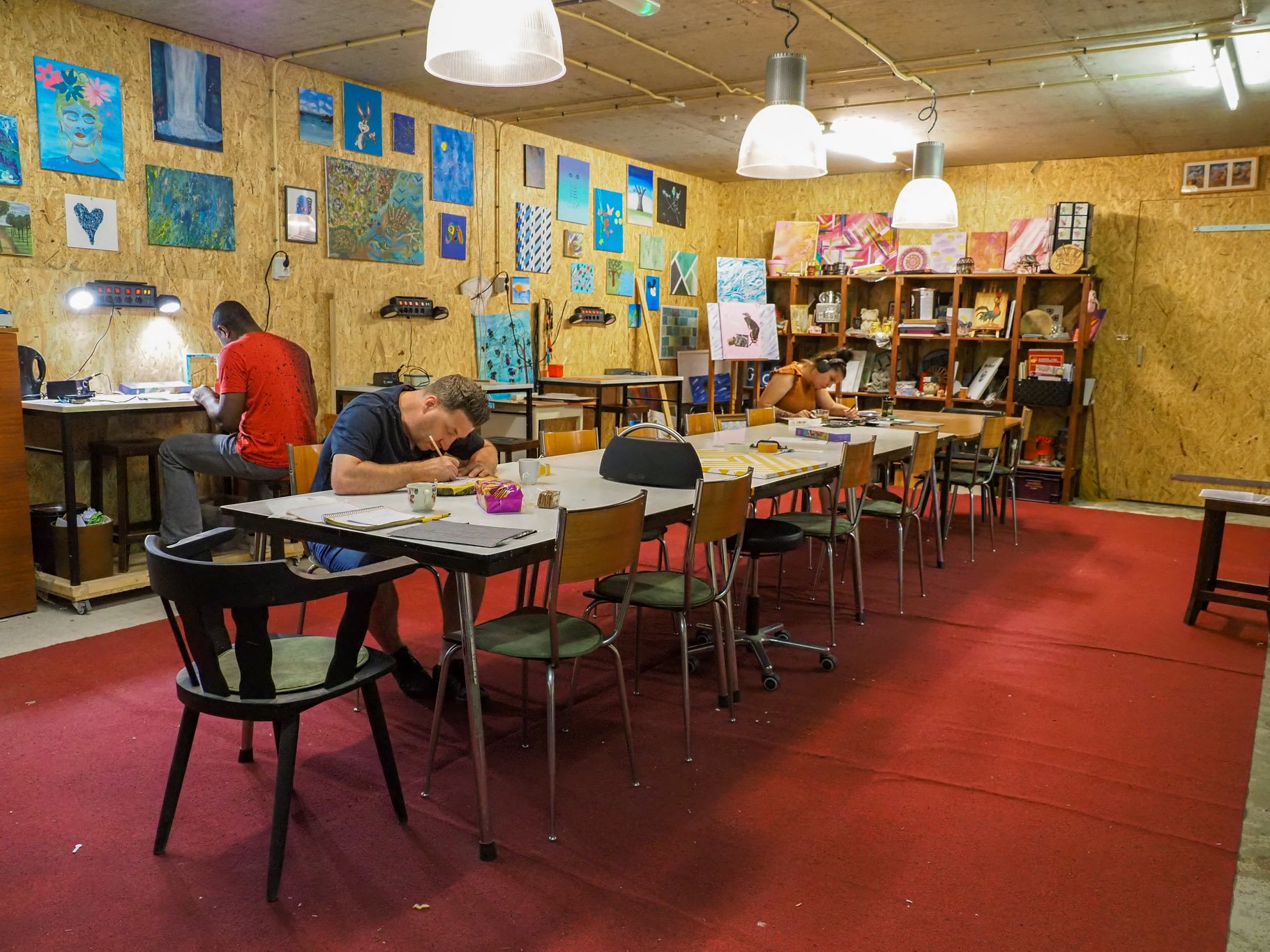 Art studio with tables and paintings.